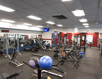 woman using resistance bands in a gym