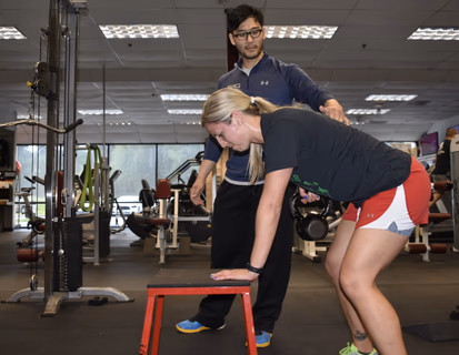 muscular man lifting weights in a gym